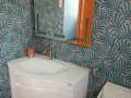 hanging-wash-basin-with-lighted-mirror-on-palm-design-bathroom-tiles